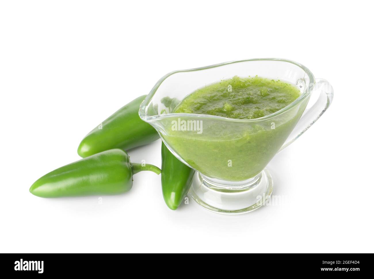Jug of Tomatillo Salsa Verde sauce and jalapeno pepper on white background Stock Photo