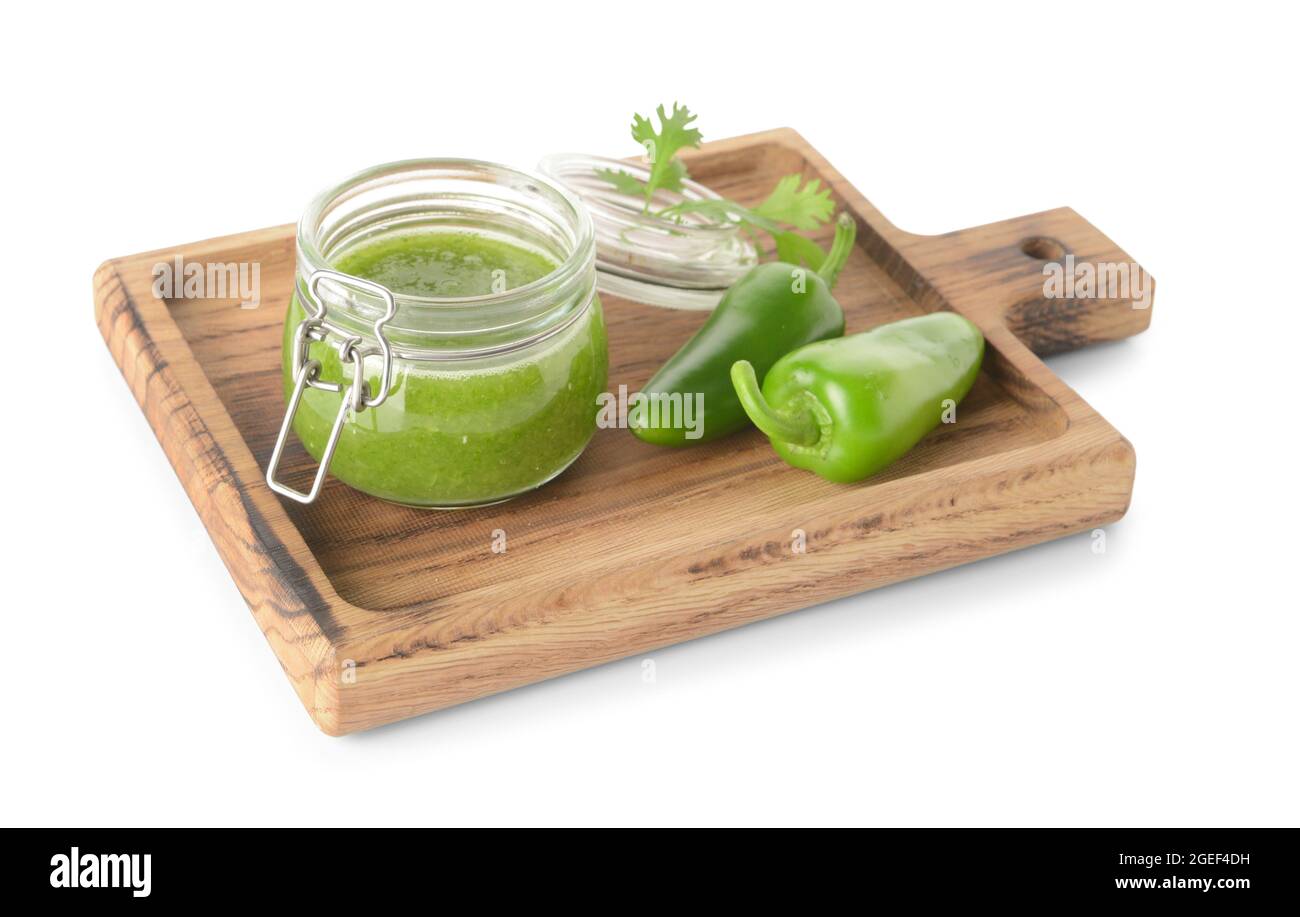 Glass jar of Tomatillo Salsa Verde sauce and jalapeno pepper on white background Stock Photo