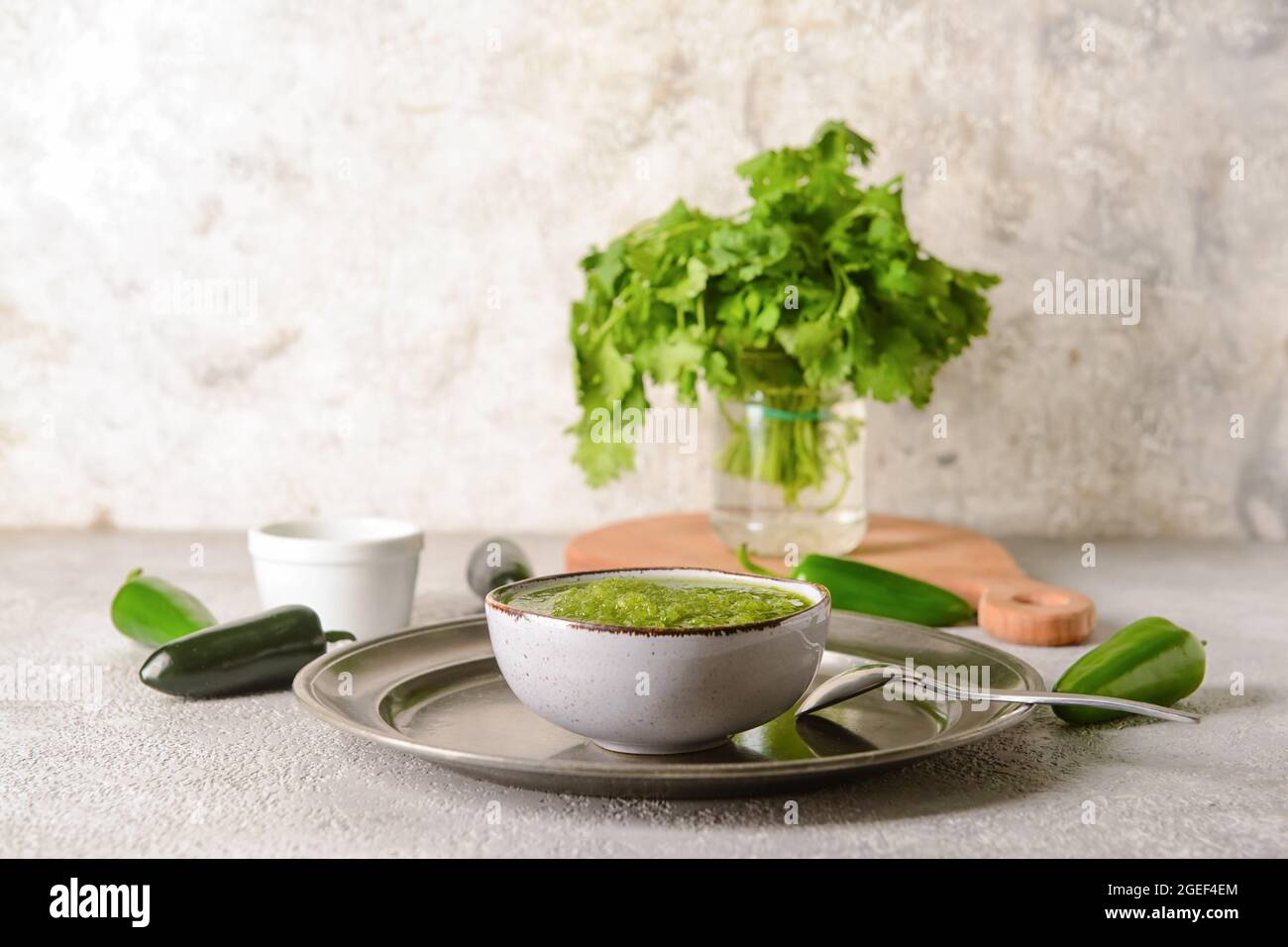 Bowl of Tomatillo Salsa Verde sauce on light background Stock Photo