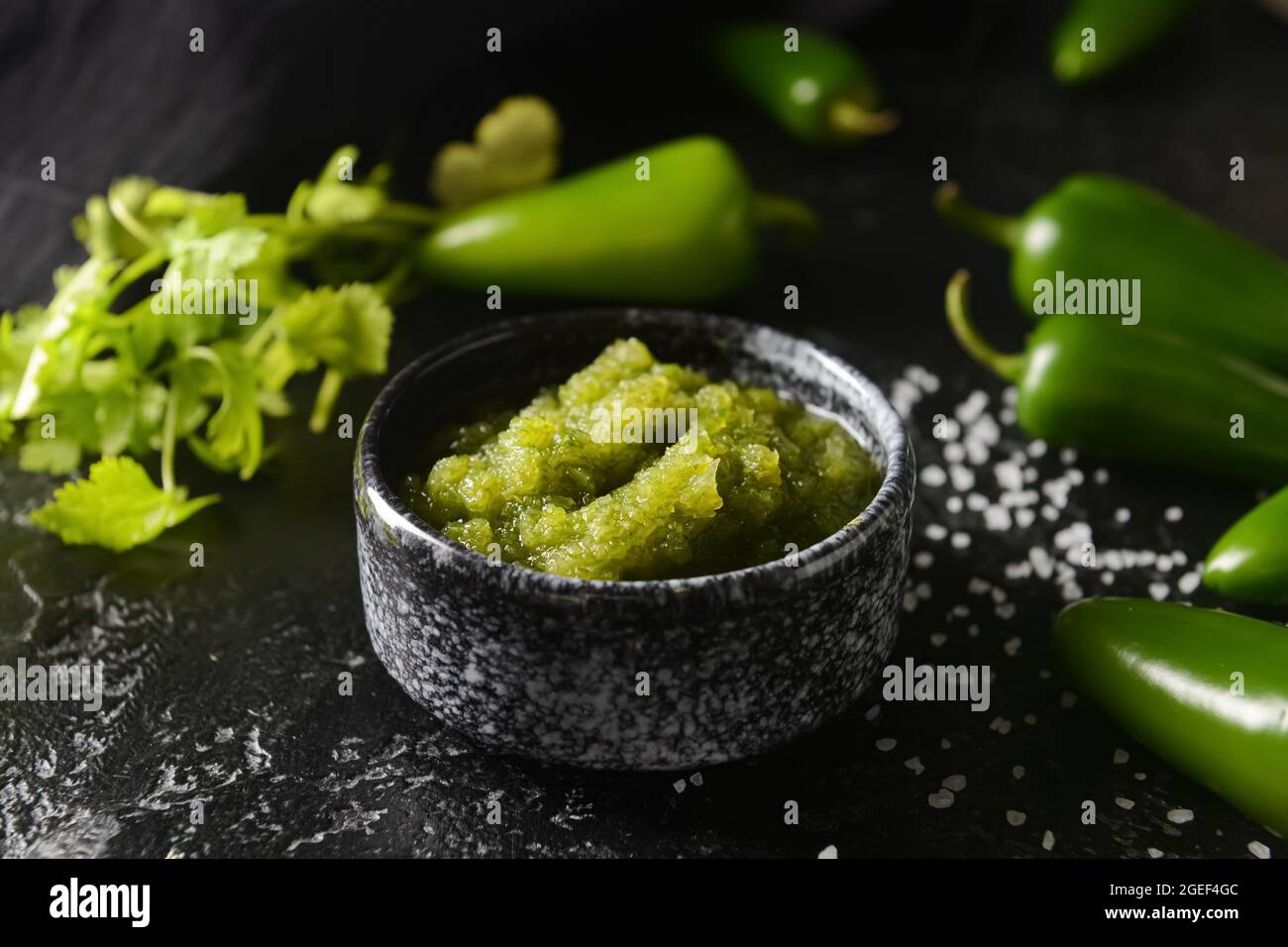 Bowl of Tomatillo Salsa Verde sauce on dark background Stock Photo Alamy