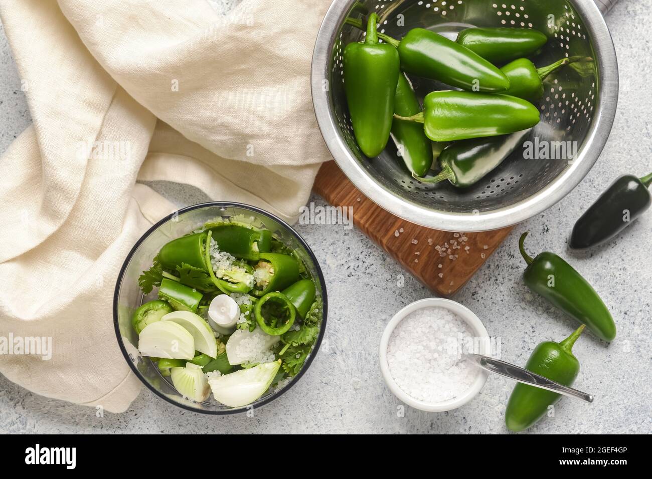 Blender with ingredients for Tomatillo Salsa Verde sauce on light background Stock Photo