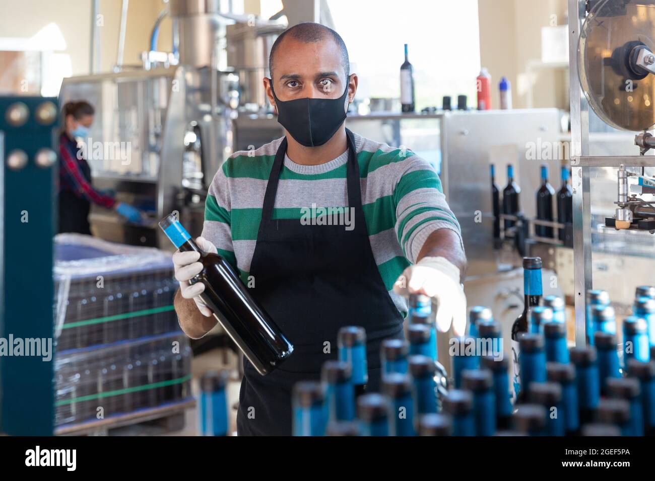 Worker of winery posing with bottled wine Stock Photo Alamy
