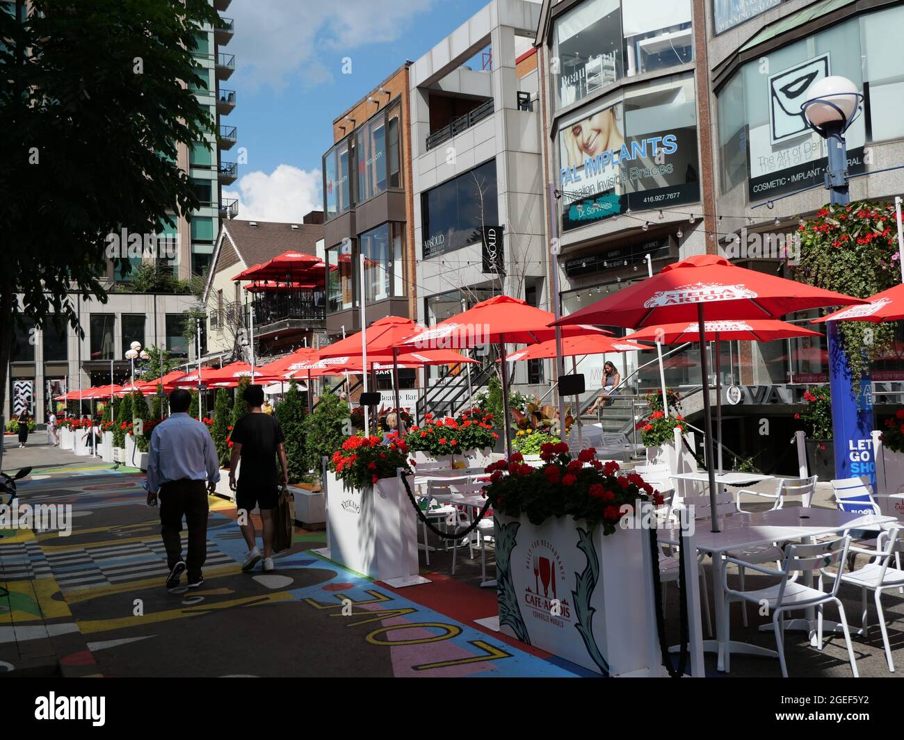 A street in the fashionable shopping area of Yorkville has been blocked off for use by restaurants for healthy outdoor dining. Stock Photo