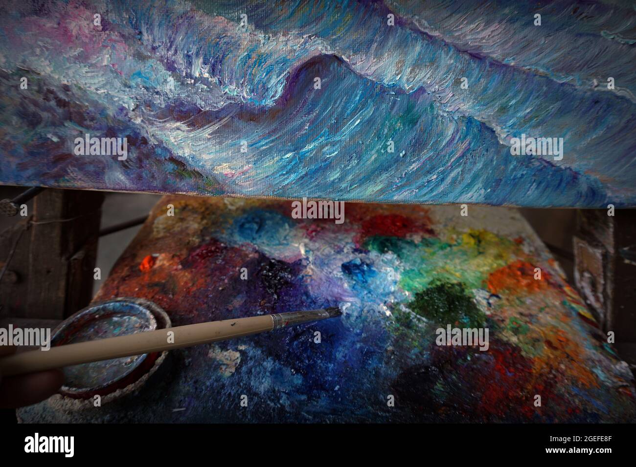 Oil, yellow, green, white, orange mixed together on a palette with