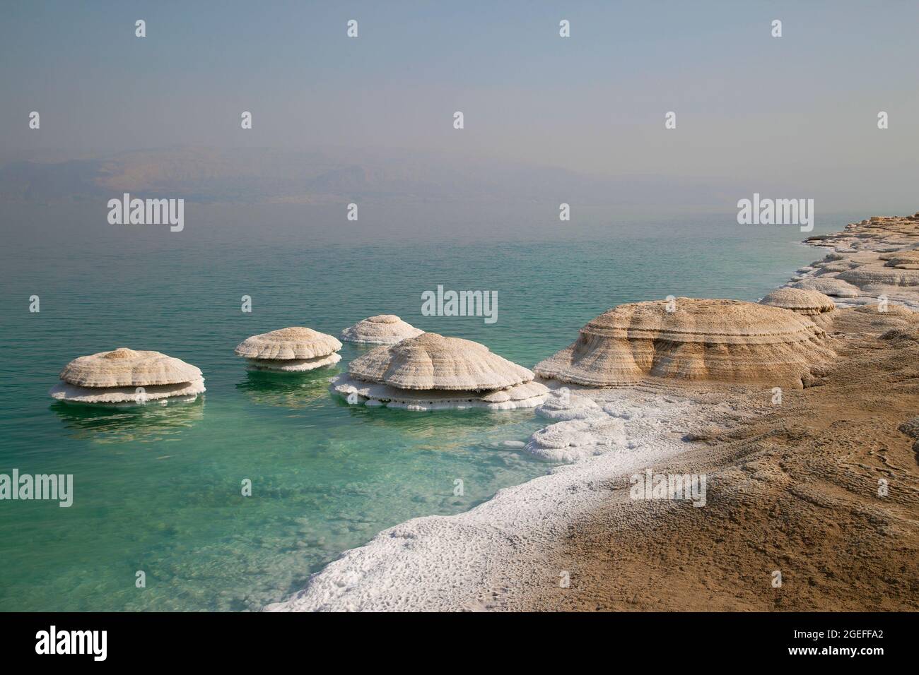 Salt chimneys on the Dead Sea coastline. They form where fresh water flows into the saline lake water and are exposed as water levels drop. Stock Photo