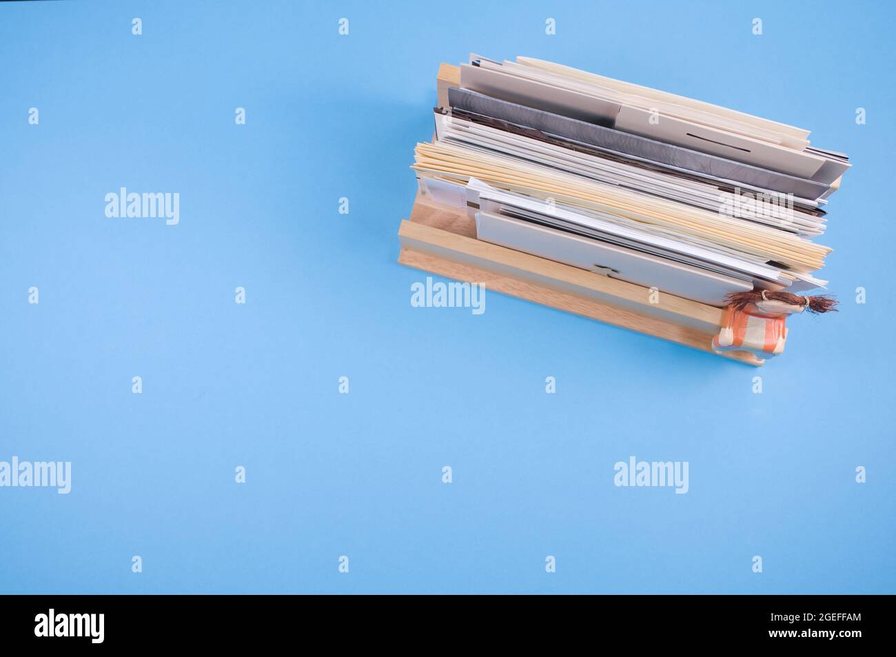 Top view of a small wooden letter holder isolated on a blue background Stock Photo