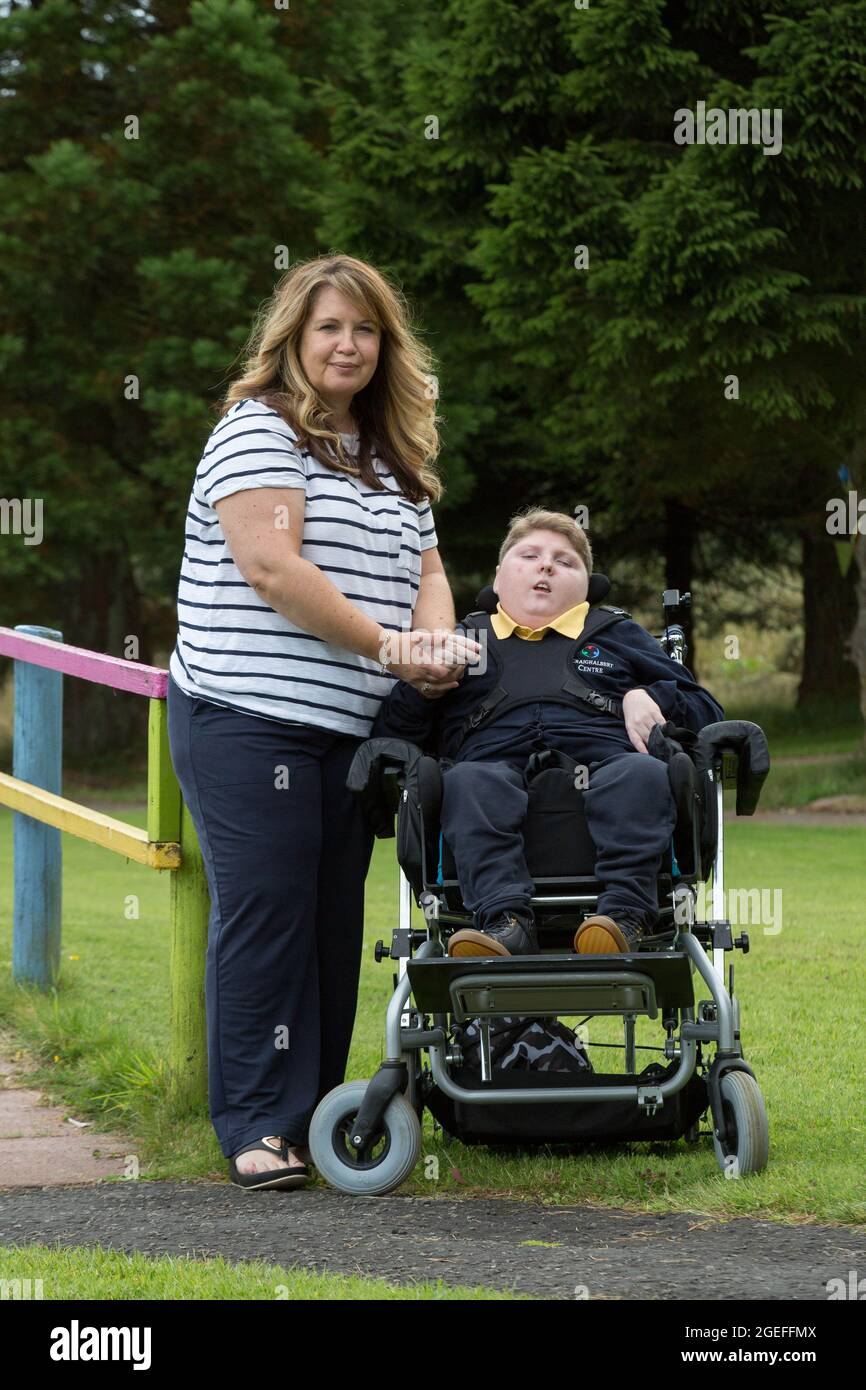 Donna Quinn with her son Logan at Craighalbert Centre, Cumbernauld. The 13 year old has serious respiratory problems and a rare neurological condition and is one of around 4,000 children in Scotland to be offered a Covid-19 vaccine under new guidance. Picture date: Wednesday August 18, 2021. Stock Photo