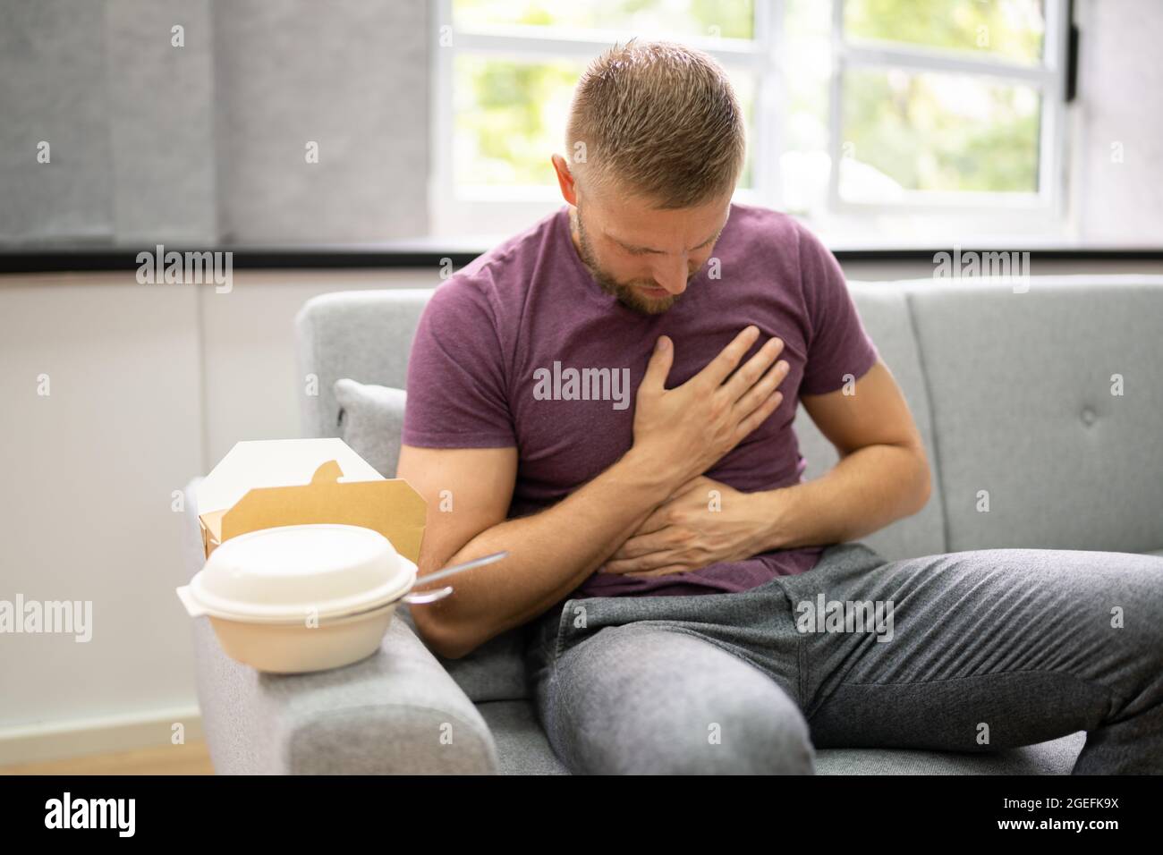 Unhealthy Fastfood Stomach Heartburn. Person After Eating Food Stock Photo