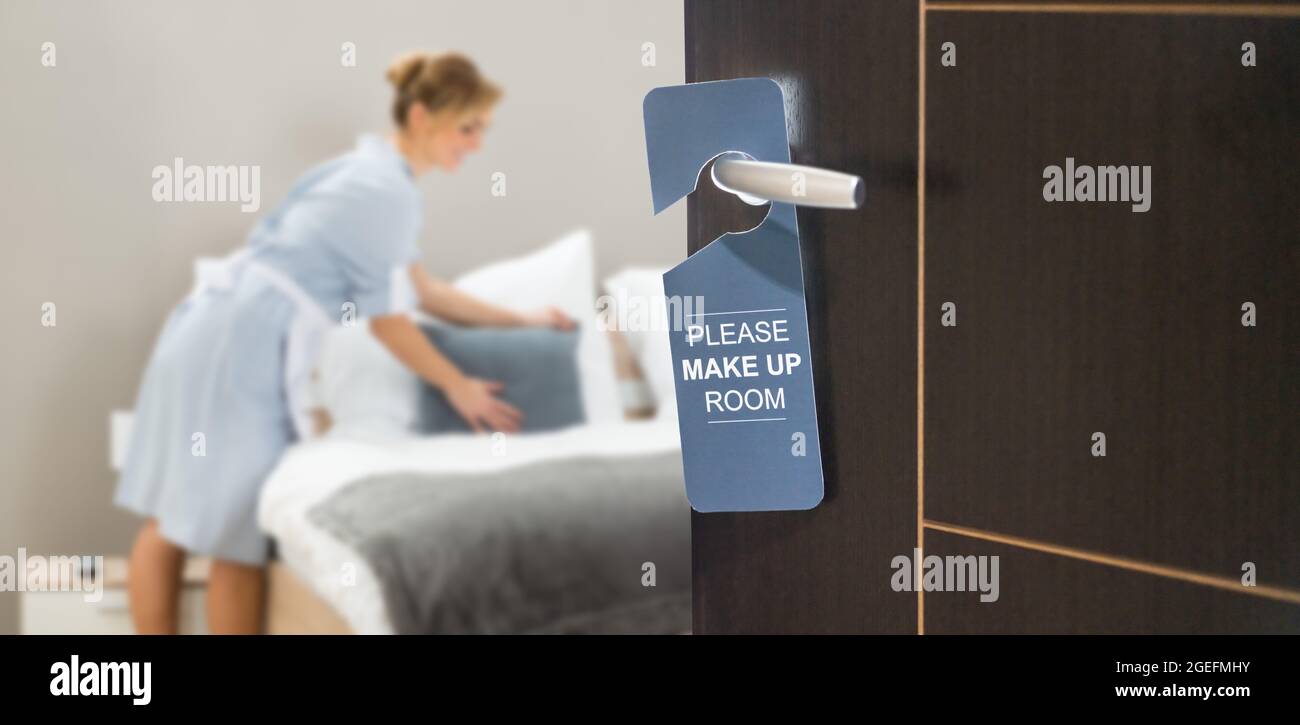 Housekeeper Cleaning Hotel Room. Bedroom Cleaner Service Stock Photo