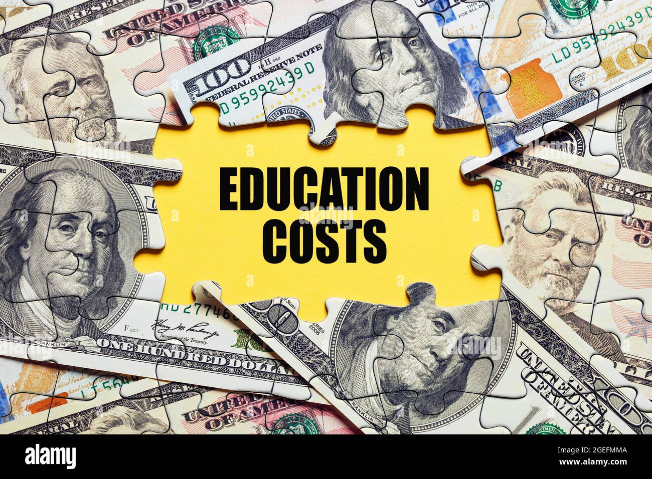 The word education costs surrounded by puzzle pieces with dollar bill money. Tuition budget or investment concept. Stock Photo