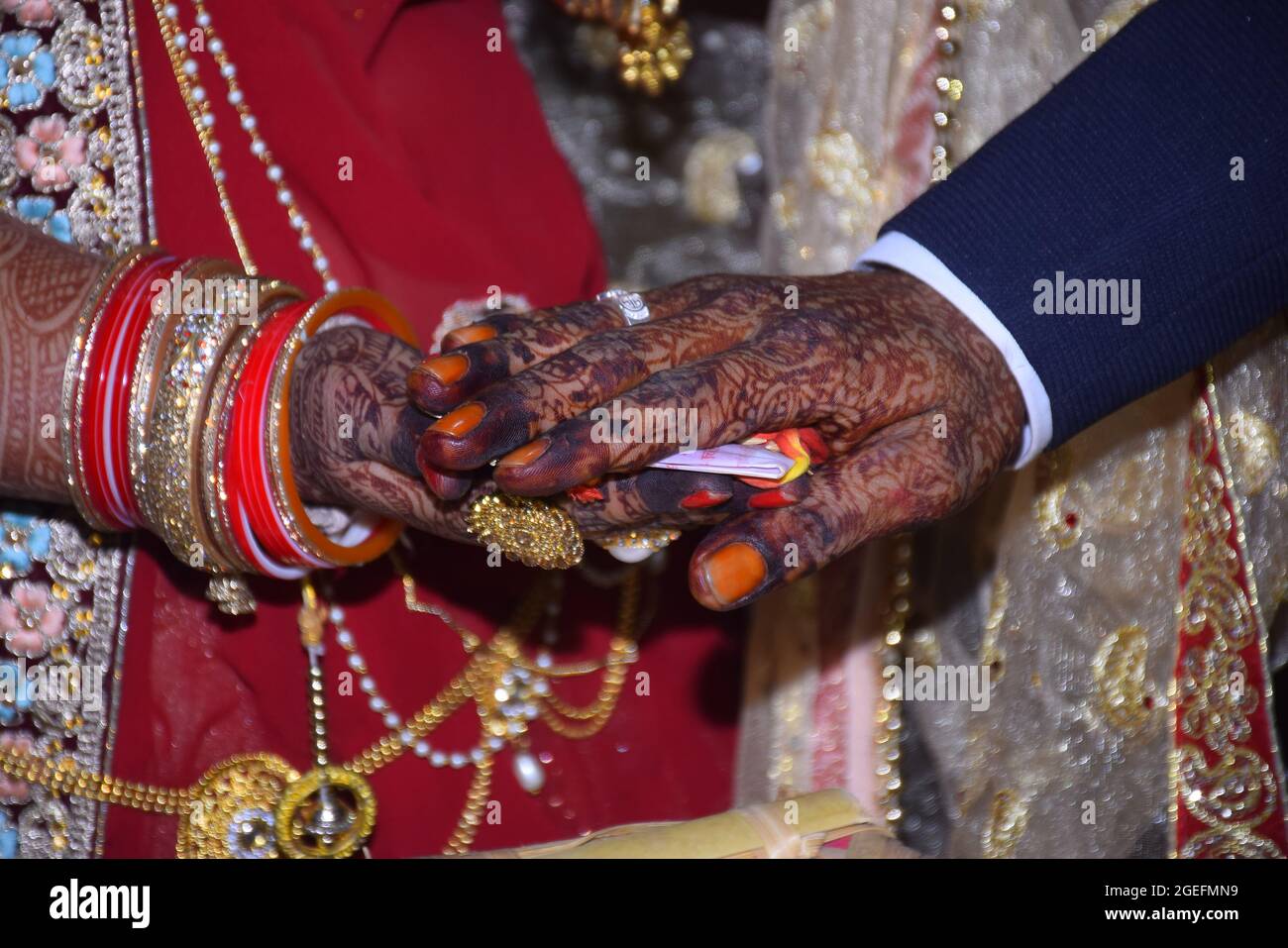 Indian Hindu Matrimonial Tradition The bride groom's hands are hand mehndi with the hands of the groom Hindu groom. Stock Photo