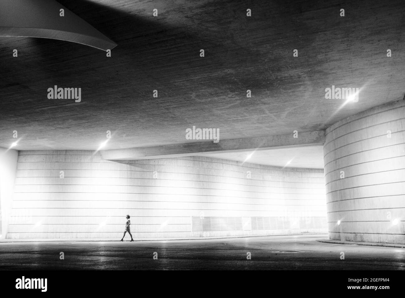Black and white art image one woman walking alone in the night city urban underground gallery scenic place Stock Photo