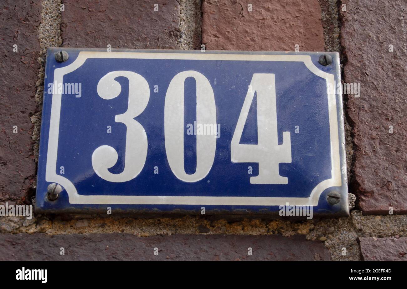 A sign on a wall with the number Stock Photo