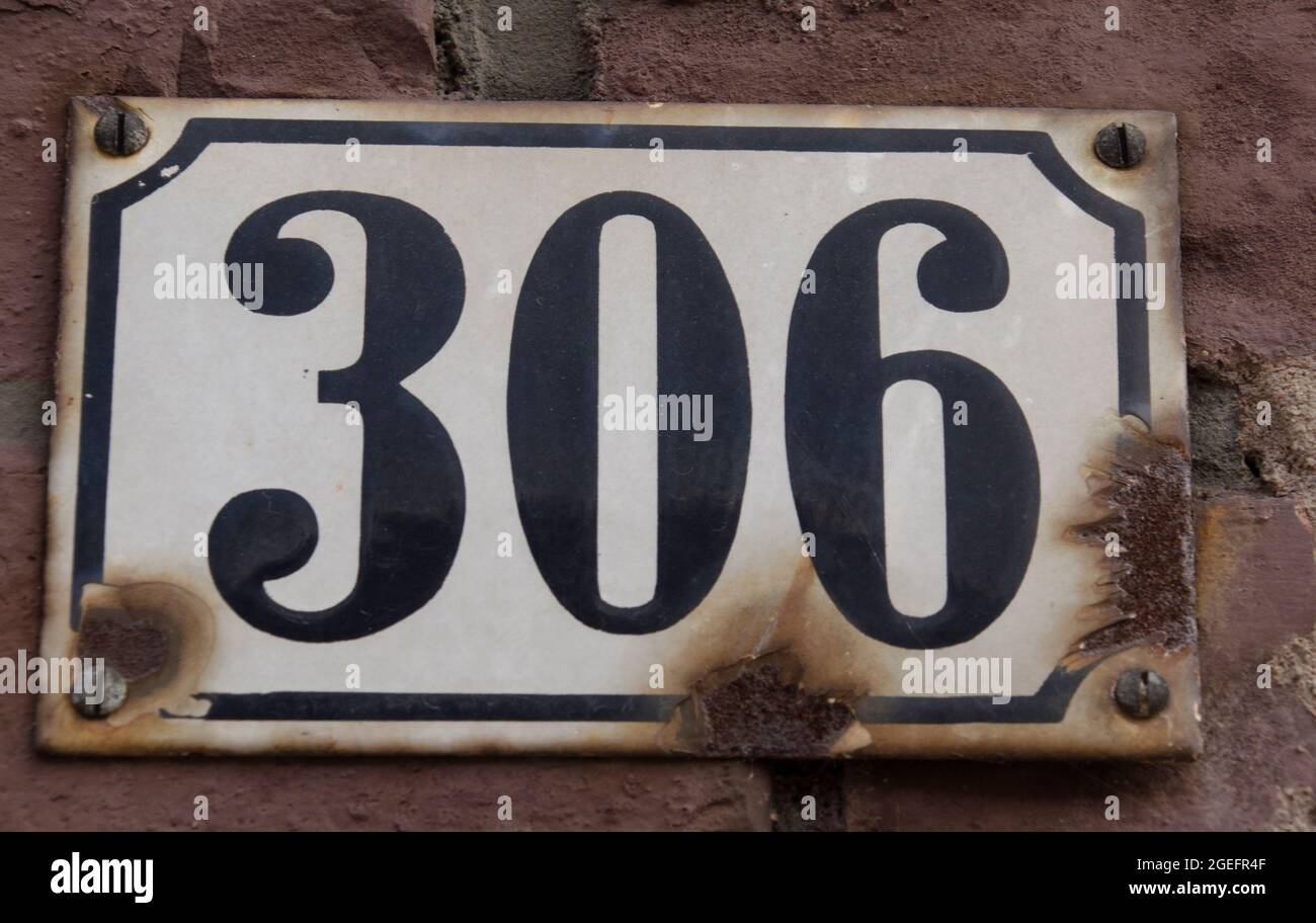 A sign on a wall with the number Stock Photo
