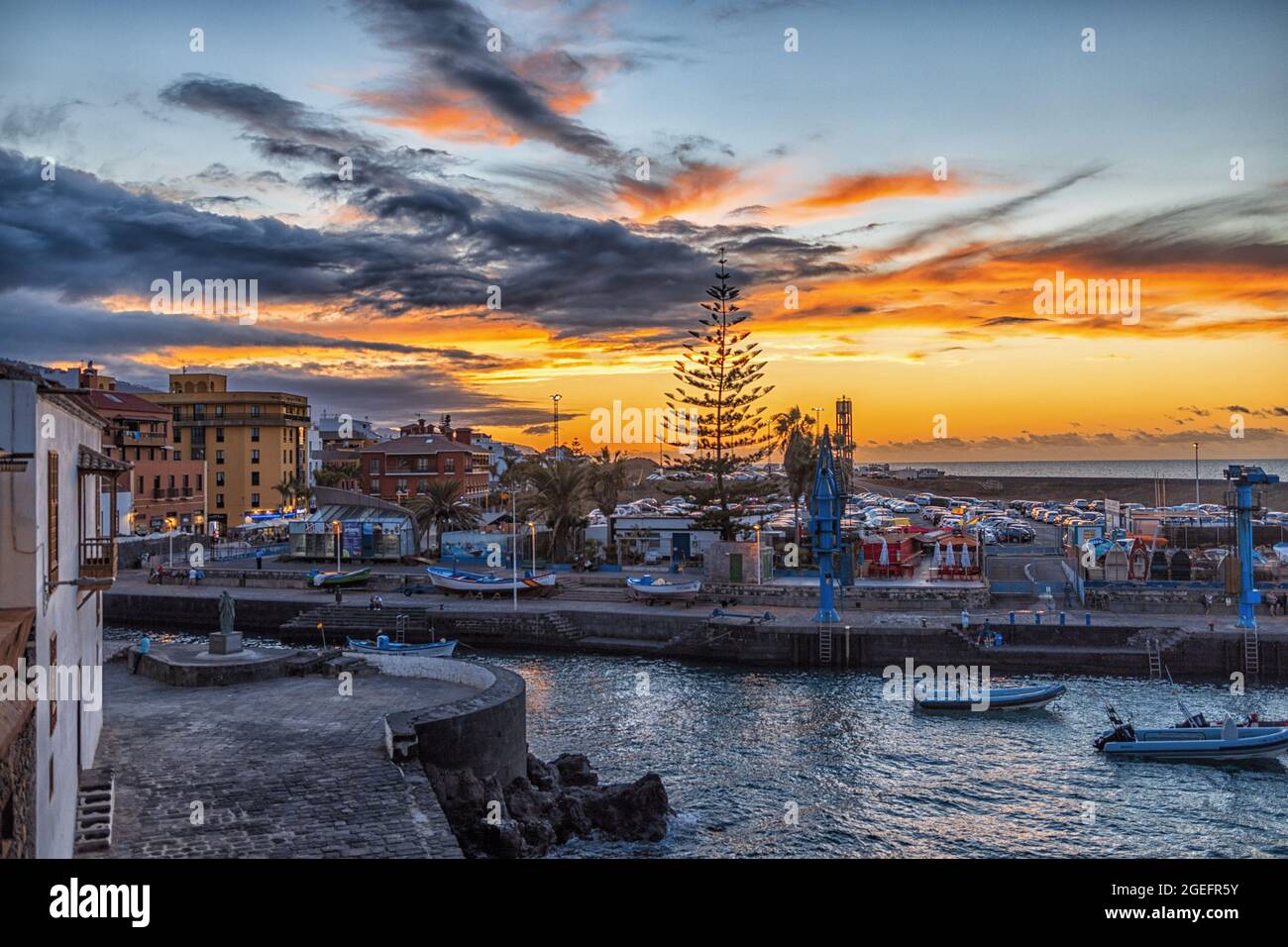 Aerial shot of a beautiful orange sunset and the city with a canal ...