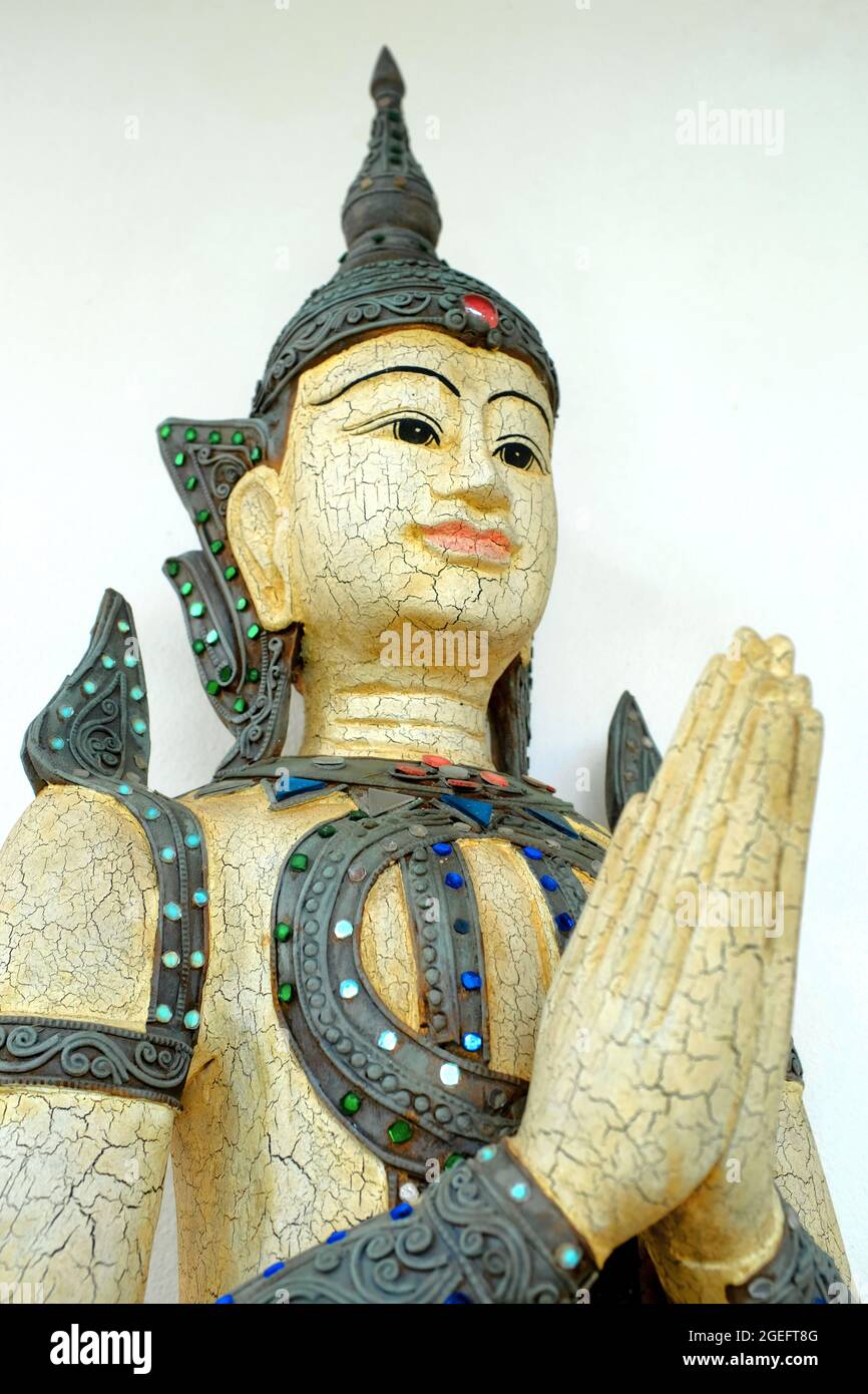 A Thai figure of Deva giving the Thai greeting of clasped hands. Stock Photo