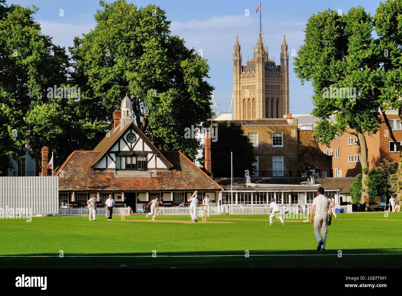 Clean Bowled! Cricket game at Vincent Square with pavilion and Houses of Parliament, soon before sunset in Westminster, London, England Stock Photo