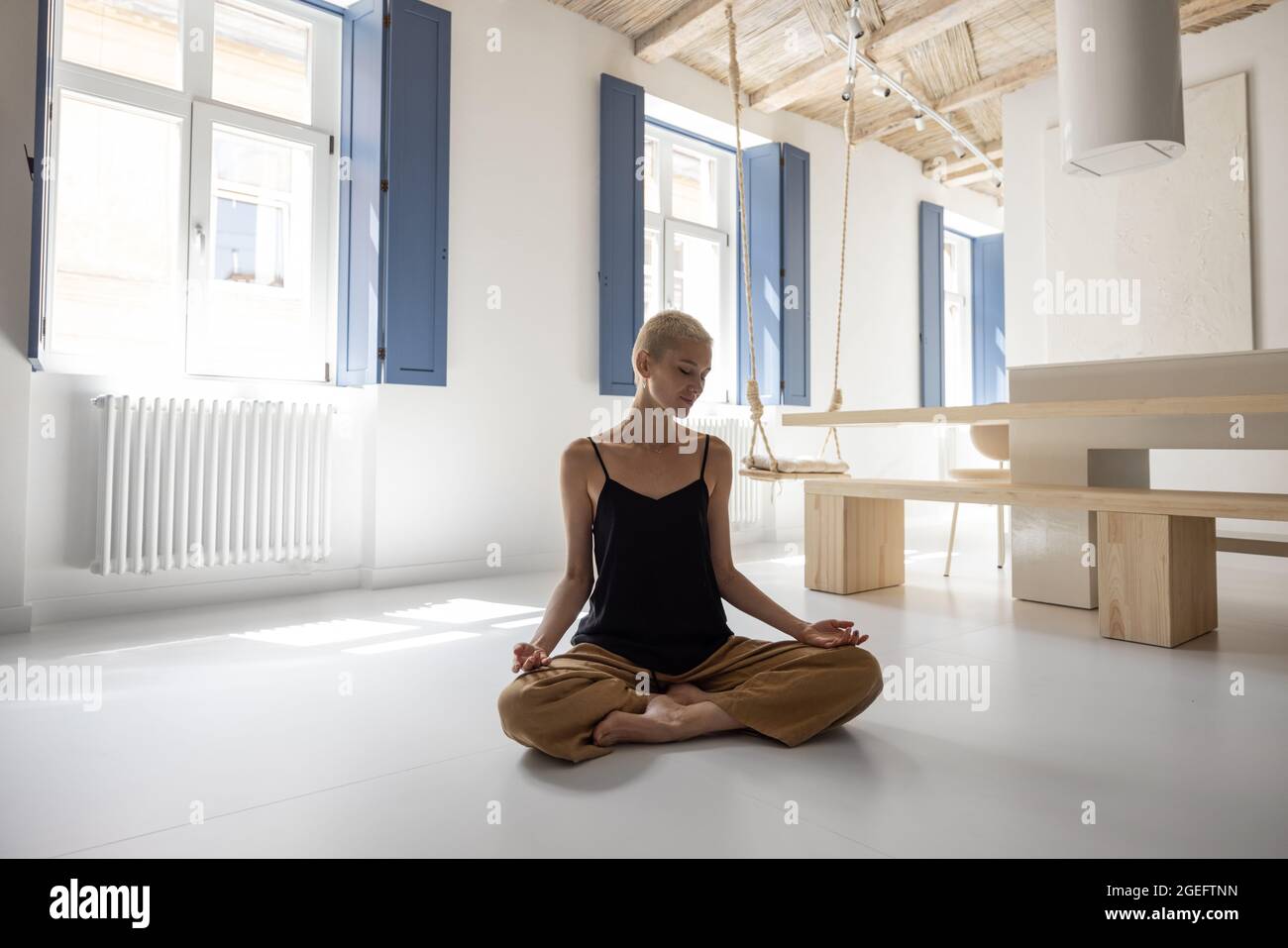 Woman meditating at home Stock Photo