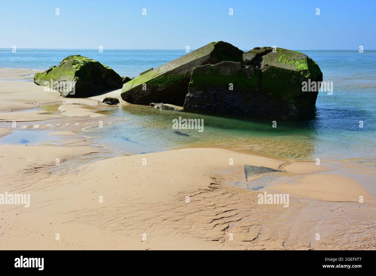 France, Aquitaine, following the coastal retreat, this bunker is ripped open and silted up gy currents, tides, storms and increase of sea level. Stock Photo