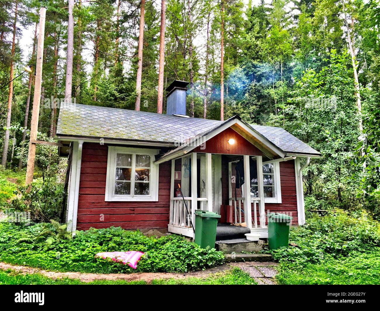 Small wooden house in the green forest Stock Photo - Alamy
