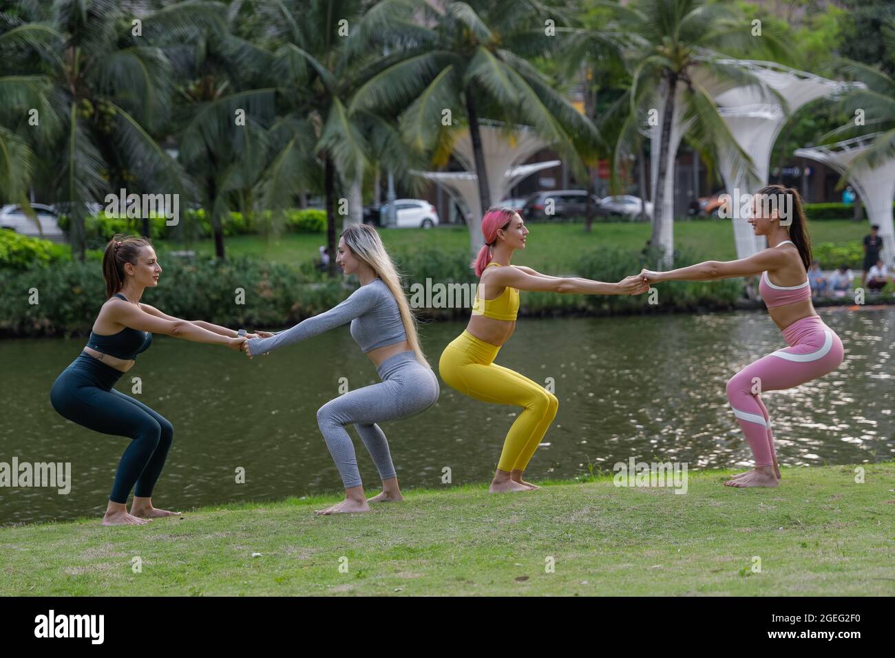 Four women in fitness wear standing together for a selfie after