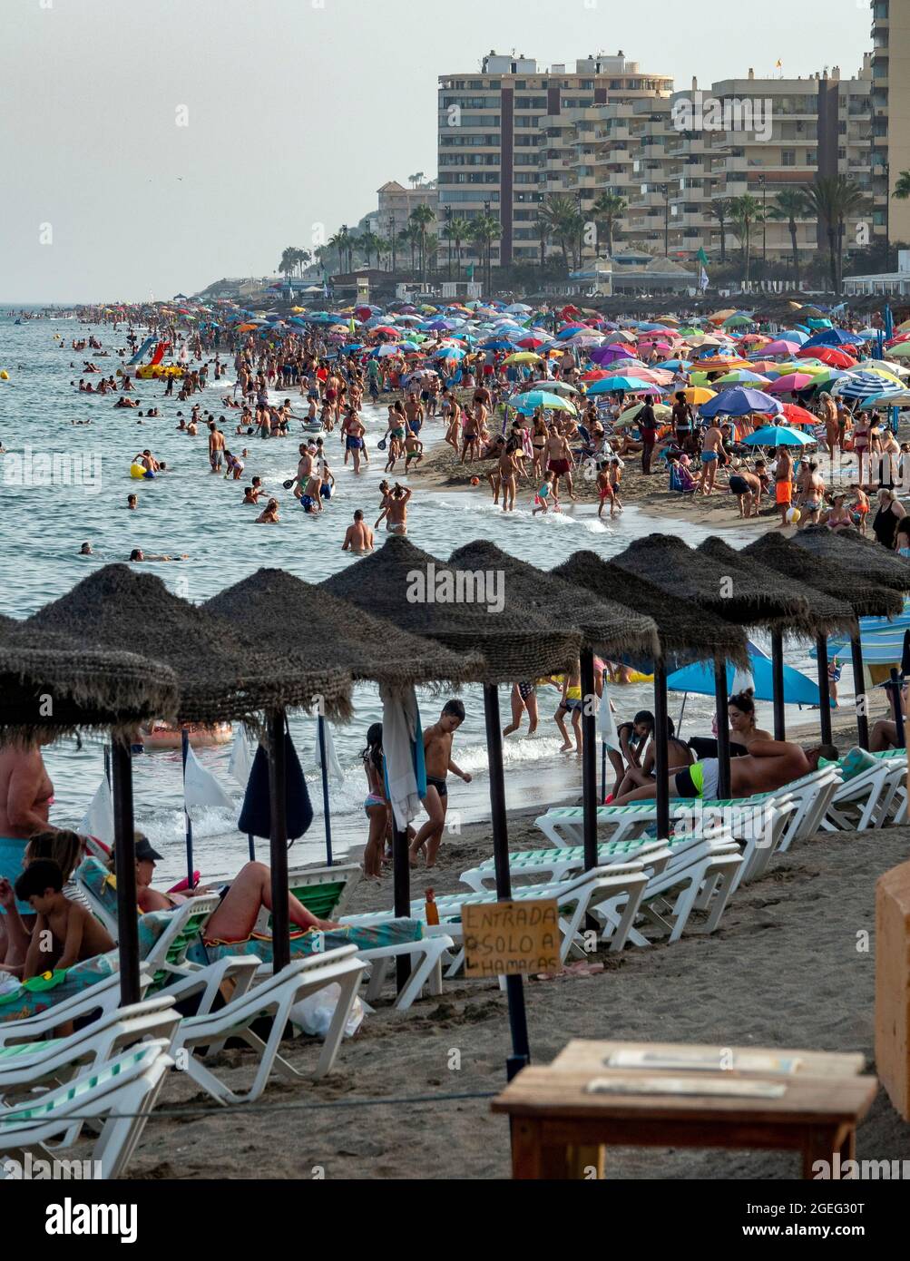 pic shows: Warning flags of  jellyfish on the beach on the Costa Del Sol  Brits sizzle in scorching temperatures in Fuengirola Spain   But there were Stock Photo