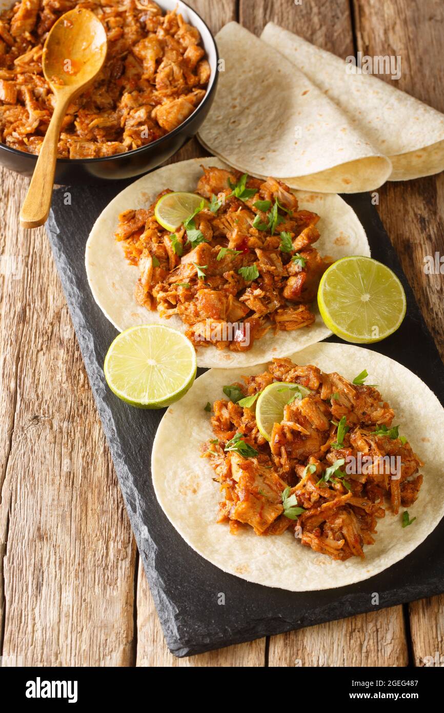 Chilorio is a scrumptious northern Mexican dish made with shredded pork simmered in a delicious chili sauce with spices closeup in the slate board on Stock Photo