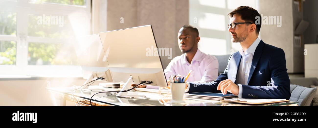 African American Business Man Employee Working In Office With Colleague Stock Photo