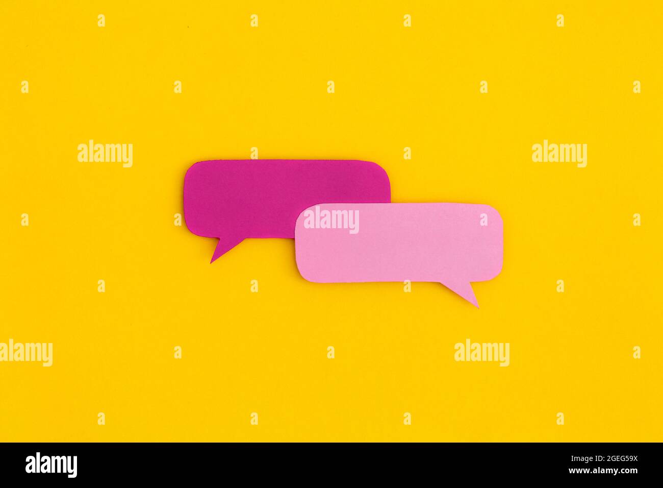 Paper speech bubbles on a yellow background. Top view with copy space ...