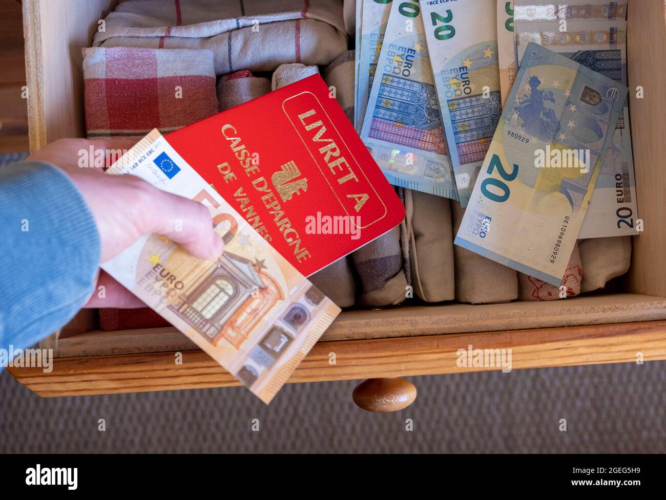 Livret A' savings account from the Caisse d'Epargne bank and Euro bank notes in a drawer Stock Photo