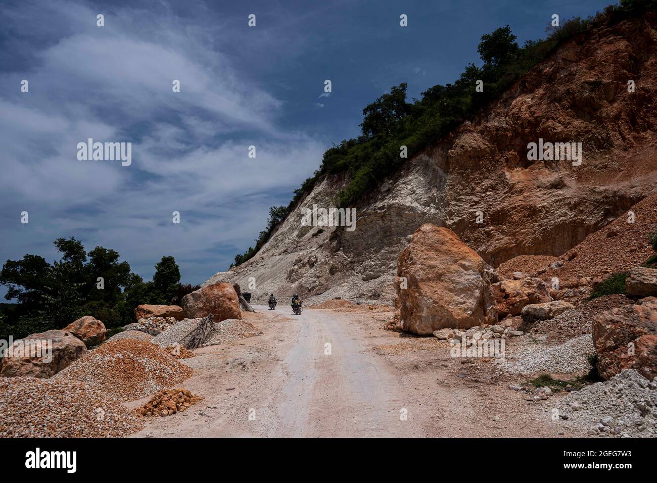 Nippes, Haiti. 19th Aug, 2021. People pass through a damaged road in