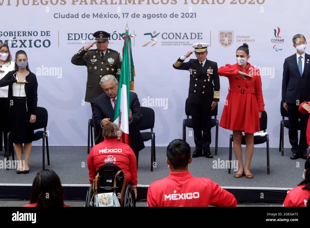 MEXICO CITY, MEXICO - AUGUST 17: Mexican President Andres Manuel Lopez Obrador, holds the nation's flag, accompanied by Mexico City Mayor Claudia Sheinbaum, Director of the National Commission for Physical Culture and Sport Ana Gabriela Guevara and ambassador of Japan in Mexico, Yasushi Takase during  a ceremony   with Mexico's athletes heading to the Tokyo 2020 Paralympic Games at National Palace on August 17, 2021 in Mexico City, Mexico. Credit: Luis Barron/Eyepix Group/The Photo Access Stock Photo