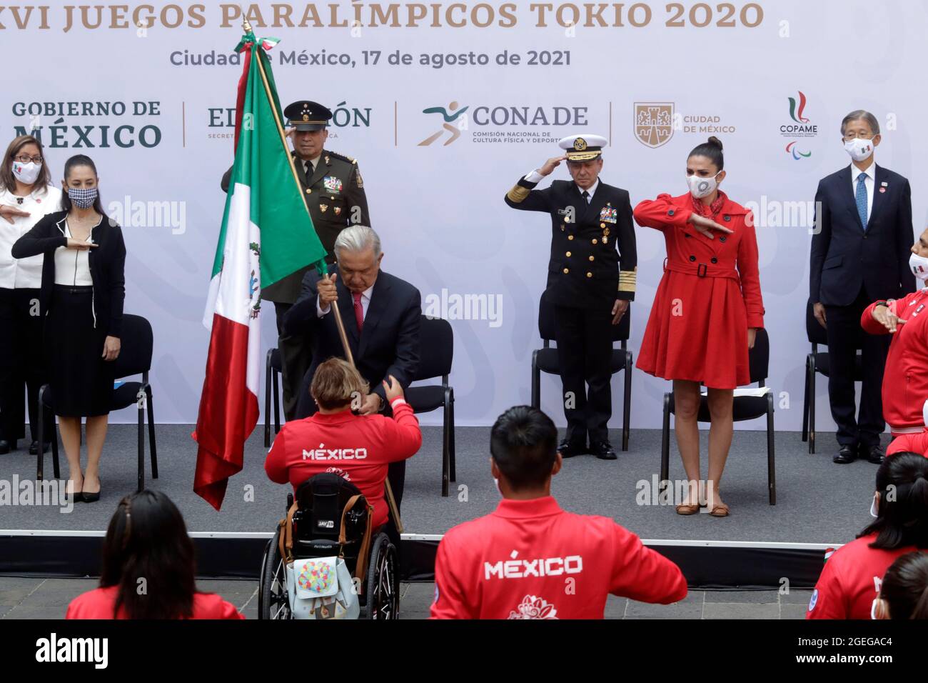 MEXICO CITY, MEXICO - AUGUST 17: Mexican President Andres Manuel Lopez Obrador, holds the nation's flag, accompanied by Mexico City Mayor Claudia Sheinbaum, Director of the National Commission for Physical Culture and Sport Ana Gabriela Guevara and ambassador of Japan in Mexico, Yasushi Takase during  a ceremony   with Mexico's athletes heading to the Tokyo 2020 Paralympic Games at National Palace on August 17, 2021 in Mexico City, Mexico. Credit: Luis Barron/Eyepix Group/The Photo Access Stock Photo