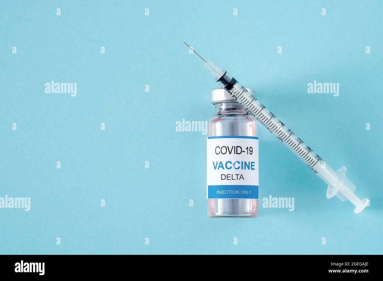 Vial with coronavirus vaccine Delta variant and syringe on blue ...