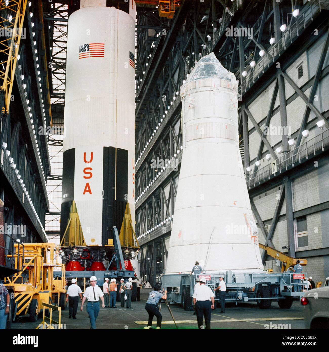 Apollo Spacecraft 104 Command/Service Module and Lunar Module 3 arrive at the Vehicle Assembly Building (VAB) for mating atop the Saturn 504 launch vehicle. The Saturn 504 stack is out of view. The Saturn V first (S-IC) stage in left background is scheduled for a later flight Stock Photo
