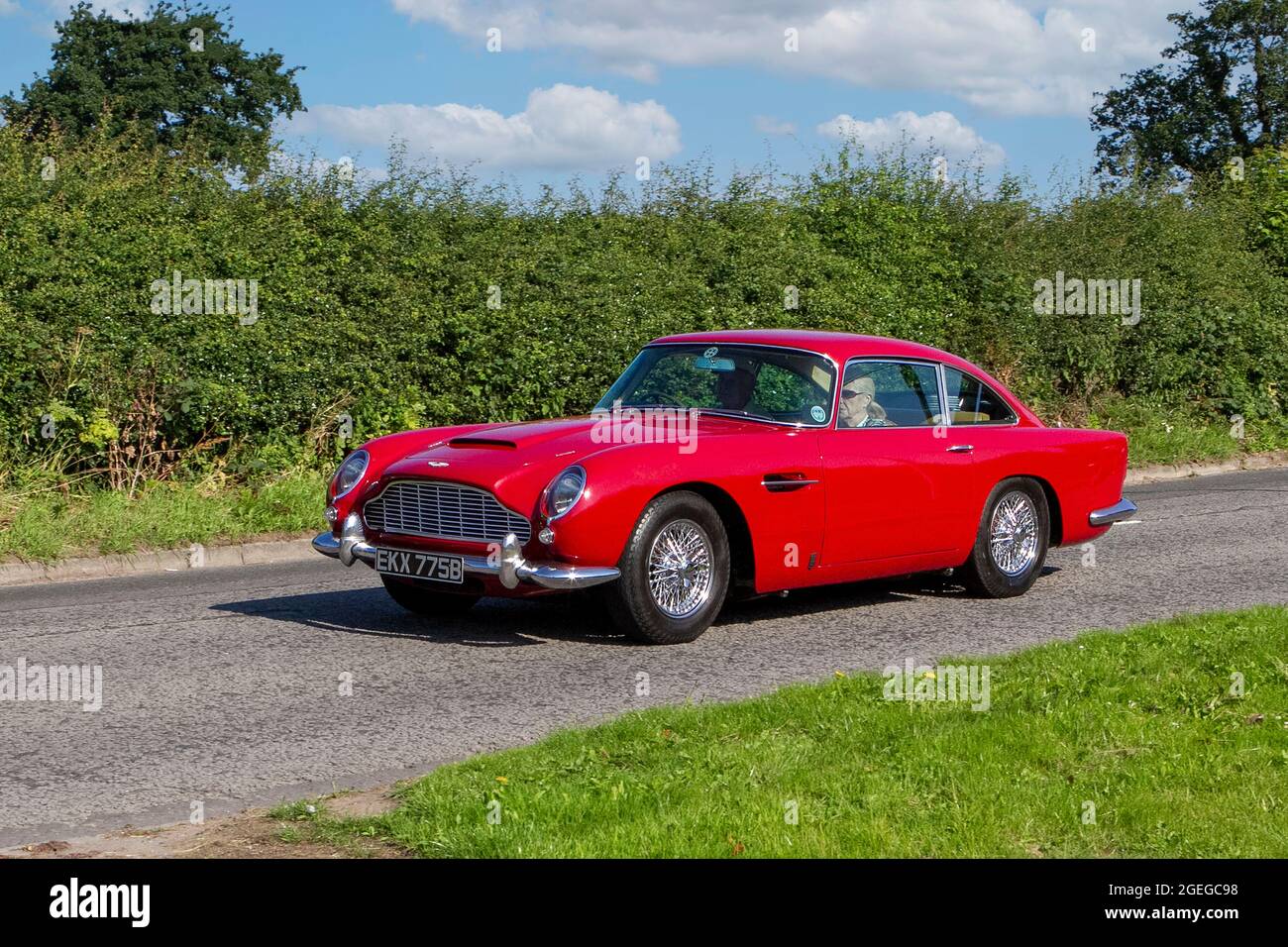 A front view of a 1960s 60s Red Aston Martin Db5 Coupe Petrol vintage classic car retro driver vehicle automobile Stock Photo