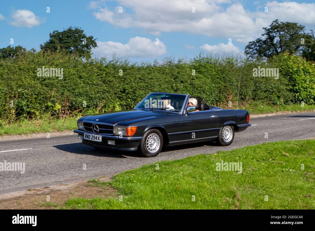 A front view of 1980s 80s Petrol Black Mercedes 280 Sl Roadster vintage classic car retro driver vehicle automobile Stock Photo