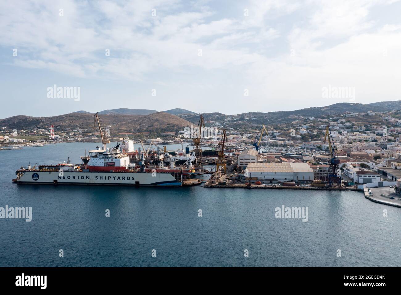 Syros island, Cyclades, Greece. May 26, 2021. Neorion shipyard harbour and industrial plant at Ermoupolis capital of Siros. Ships, cranes, internation Stock Photo