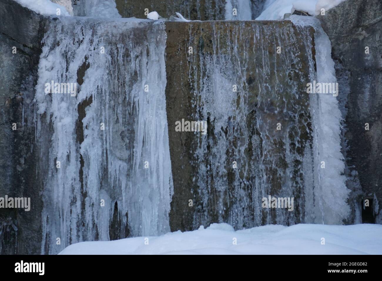 closeup icy waterfall on cement step Stock Photo