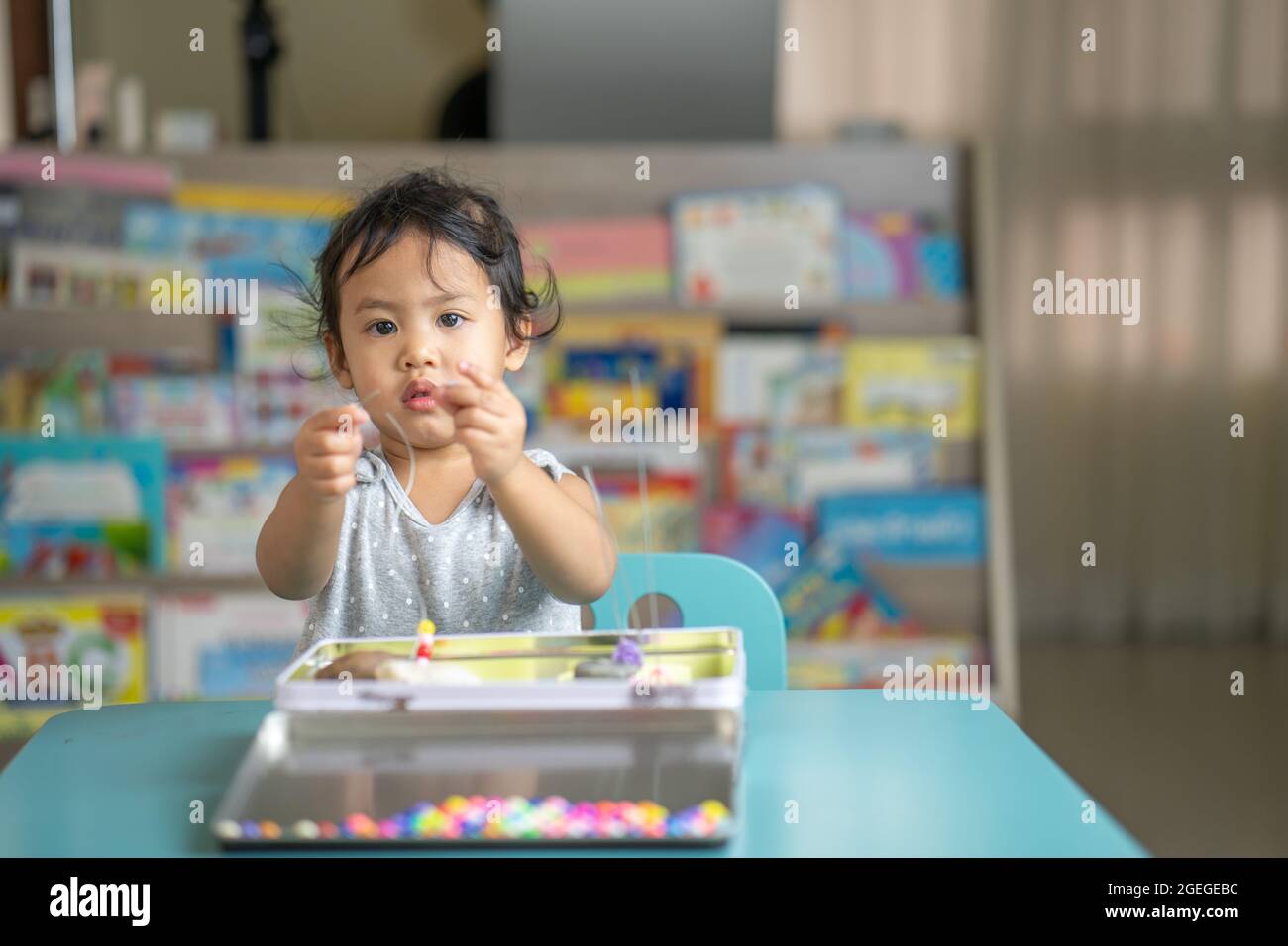 Little girl playing toys at kindergarten Stock Photo - Alamy