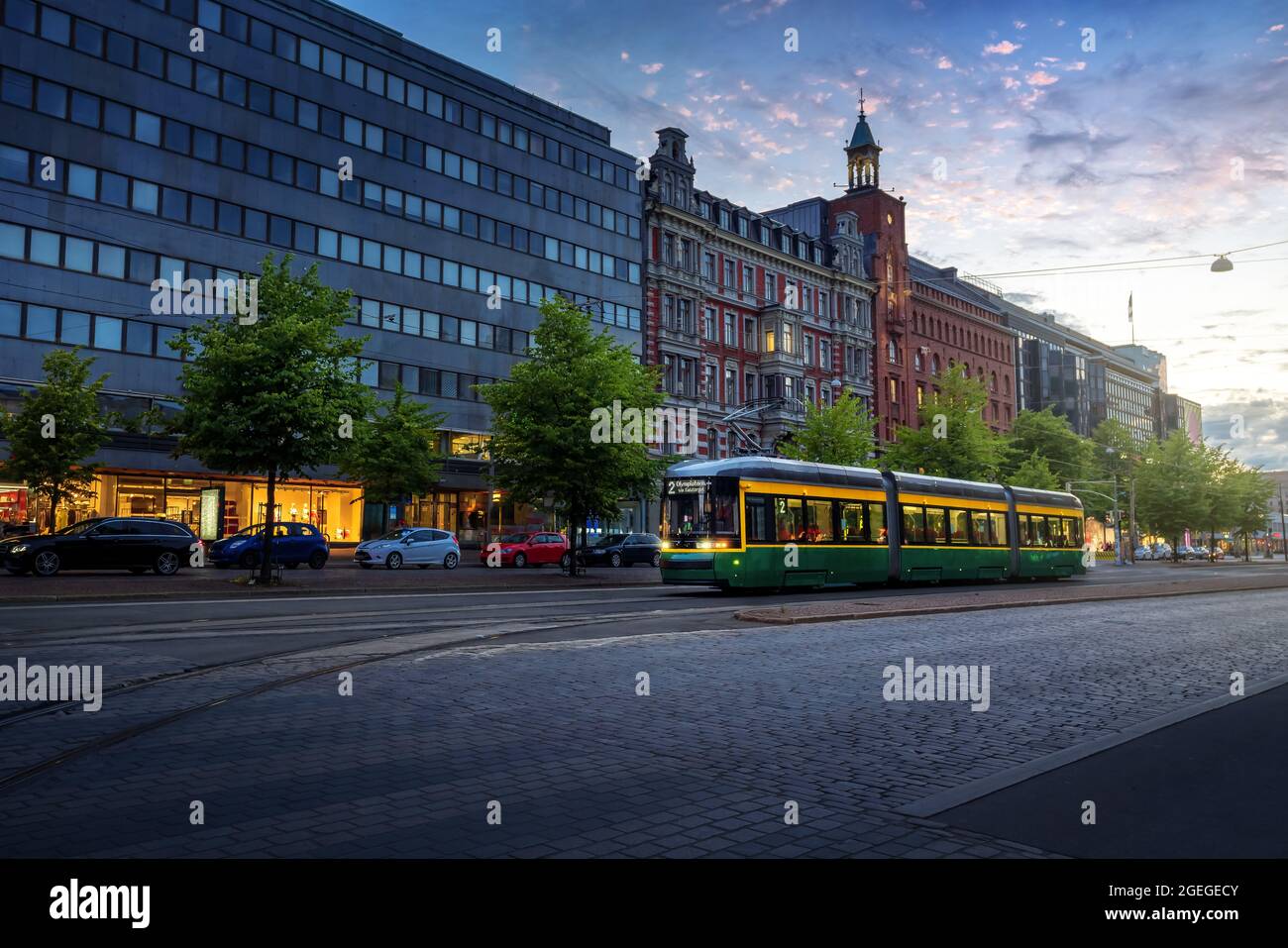 City Tram in Mannerheimintie Street at sunset - Helsinki main street at city centre - Helsinki, Finland Stock Photo
