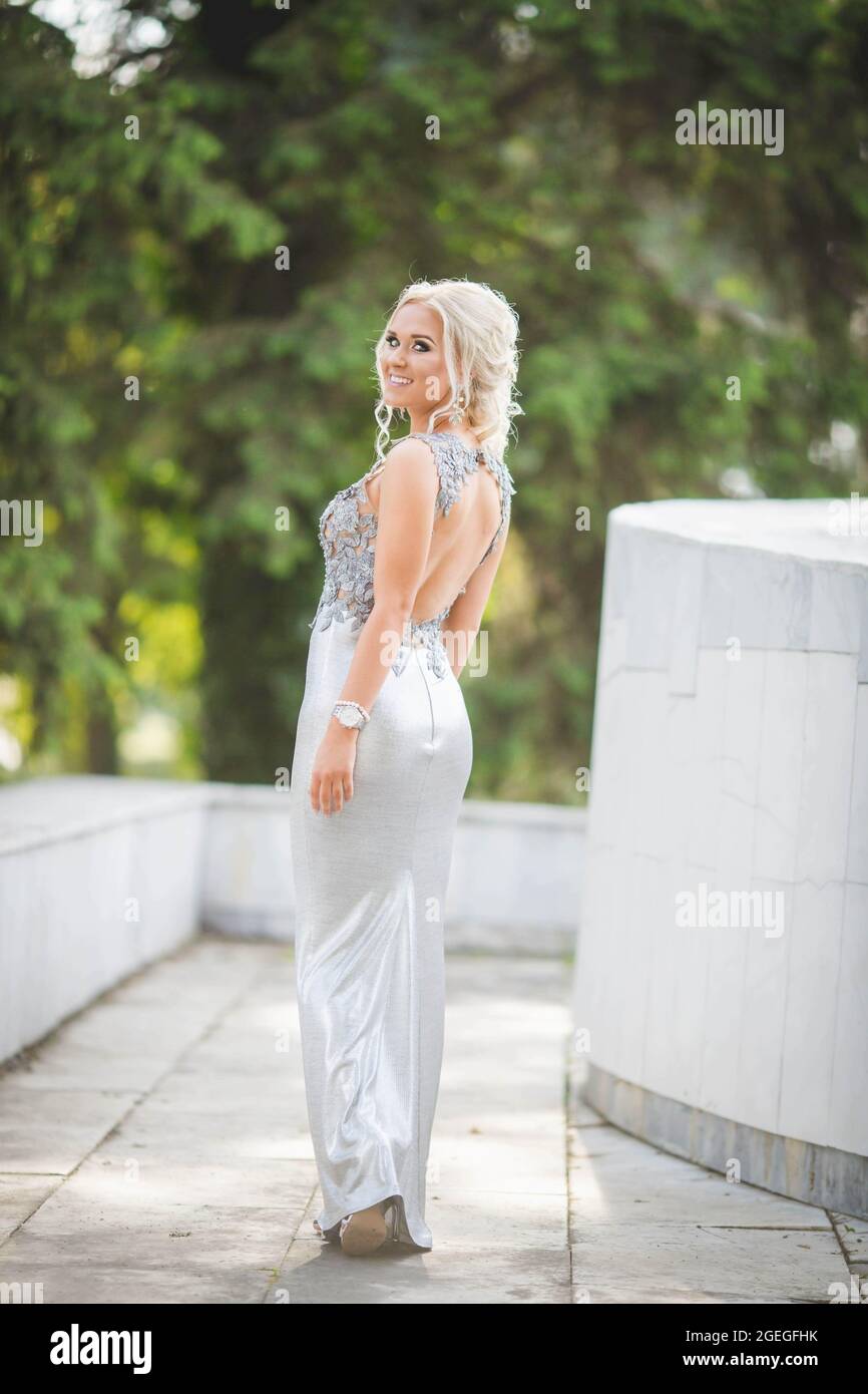 Slime blonde female is wearing a long silver dress with an open back Stock Photo - Alamy Slime blonde female is wearing a long silver dress with an open back Stock Photo - Alamy