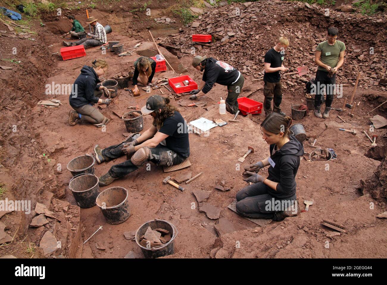 Georgenthal, Germany. 20th Aug, 2021. A team of paleontologists and geologists digs at the Bromacker between Tambach-Dietharz and Georgenthal. During this year's excavations at the globally significant fossil site in the Thuringian Forest, researchers have secured a huge amount of finds. Credit: Martin Wichmann/dpa-Zentralbild/dpa/Alamy Live News Stock Photo