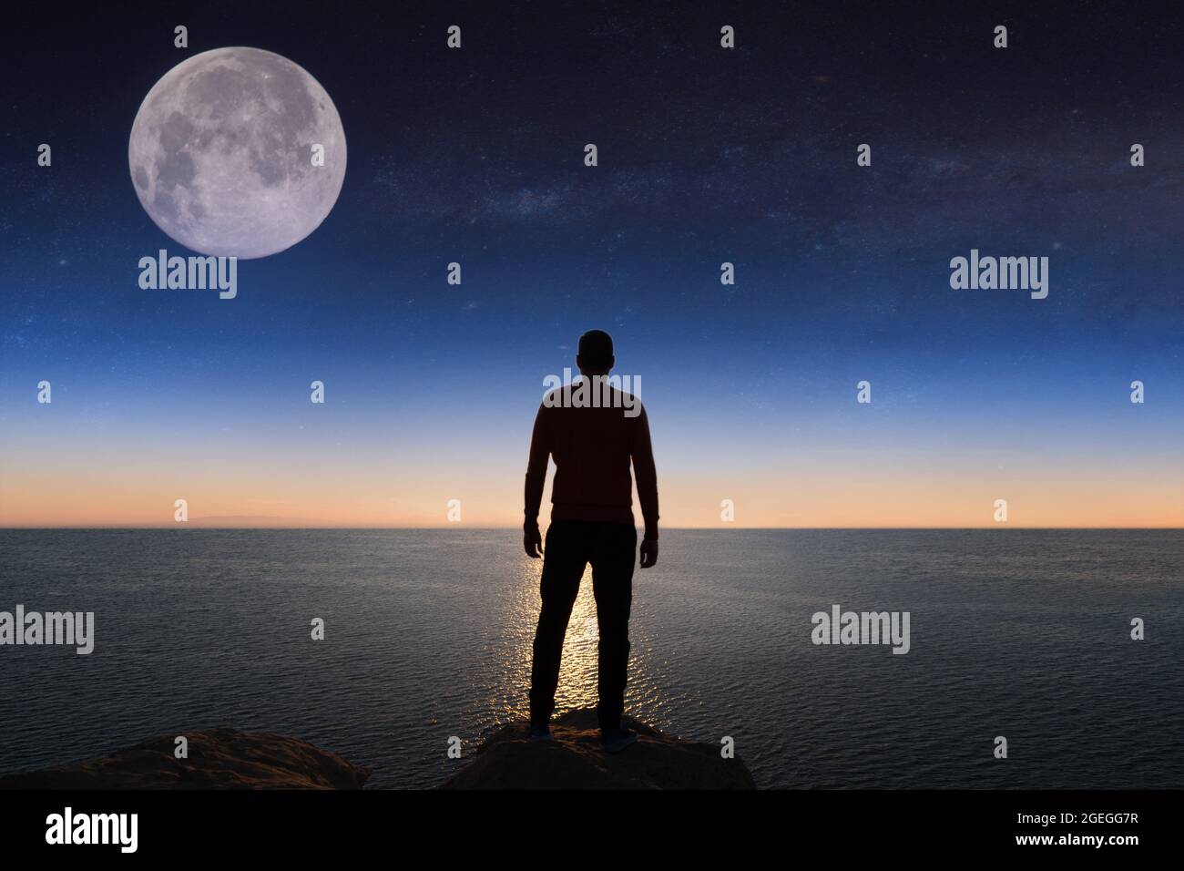 Silhouette of man is watching sunset over the sea and cliffs Stock ...