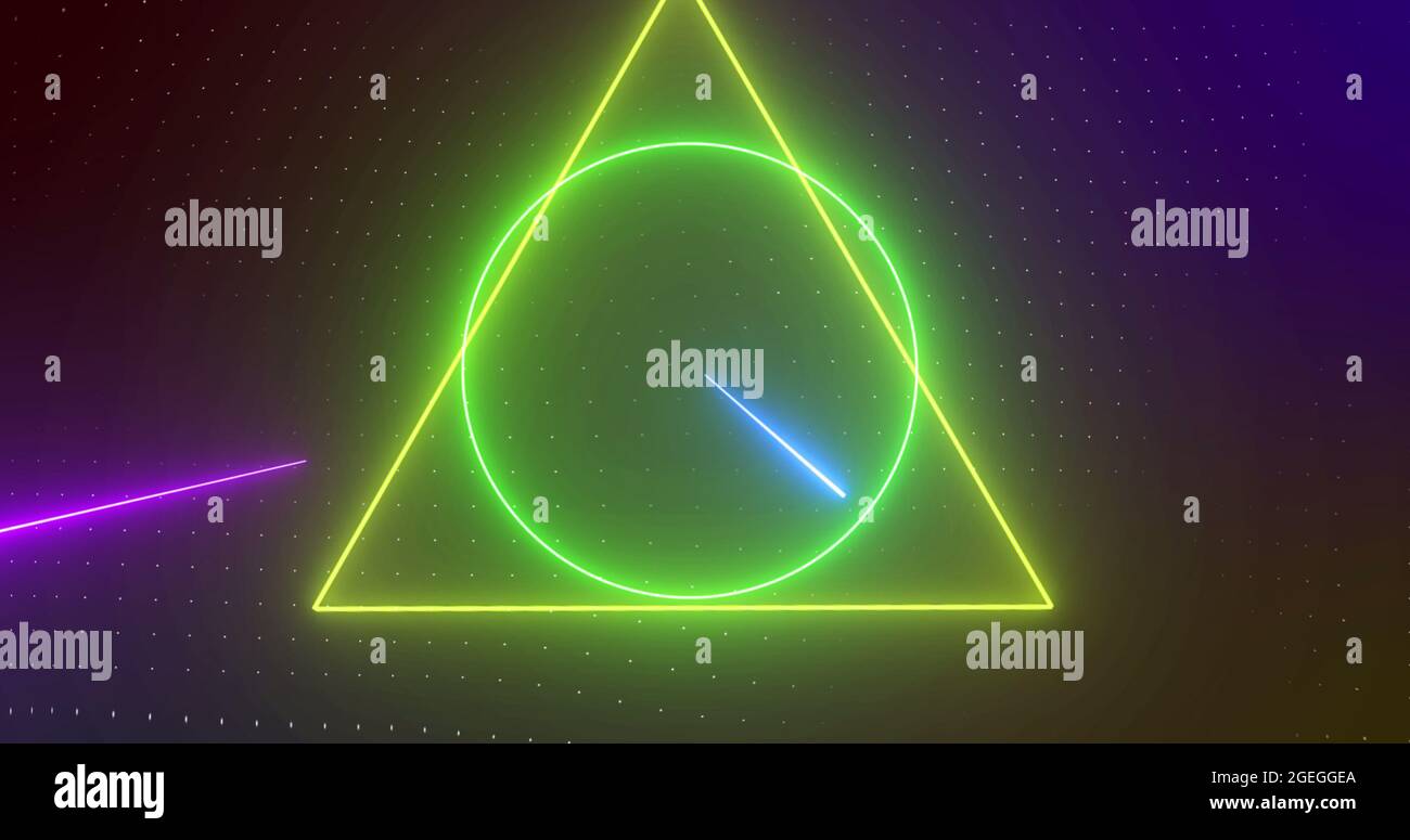 Image of rotating yellow, orange, green neon shapes with pink and blue lasers, on black Stock Photo