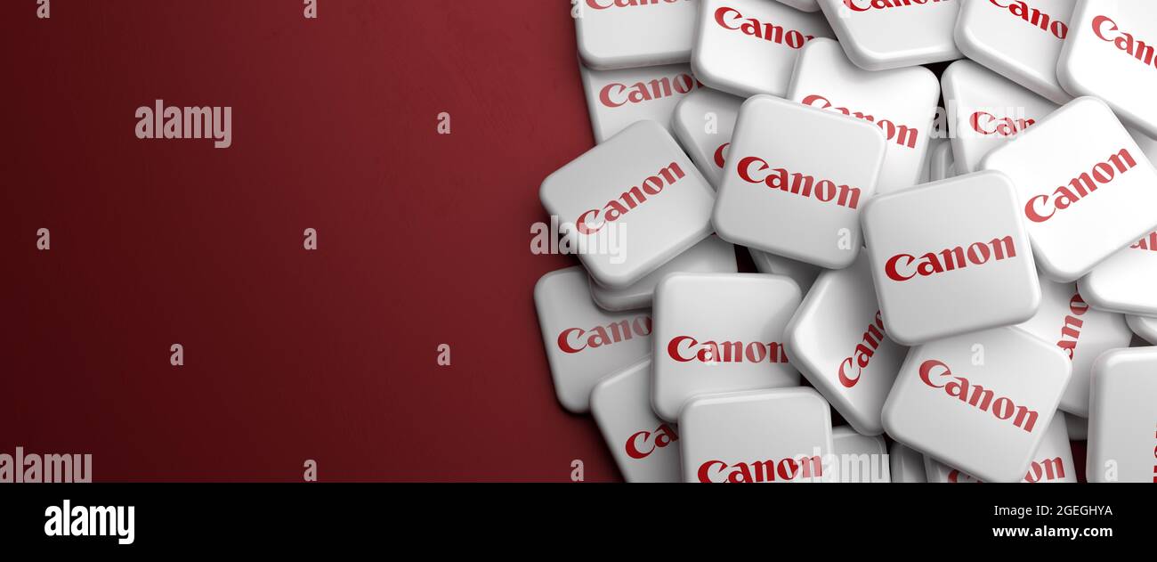 Logos of the Japanese optics and imaging company Canon Inc. on a heap