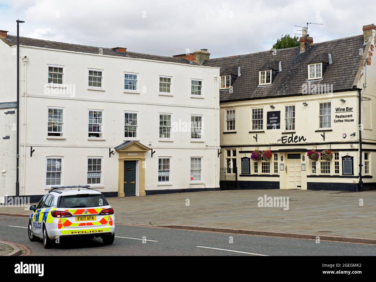 Police car passing the Market Square, Grantham, Lincolnshire, England