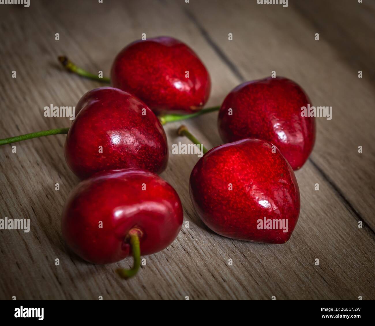 Set of five fresh red cherry fruits, closeup photo of healthy sweet