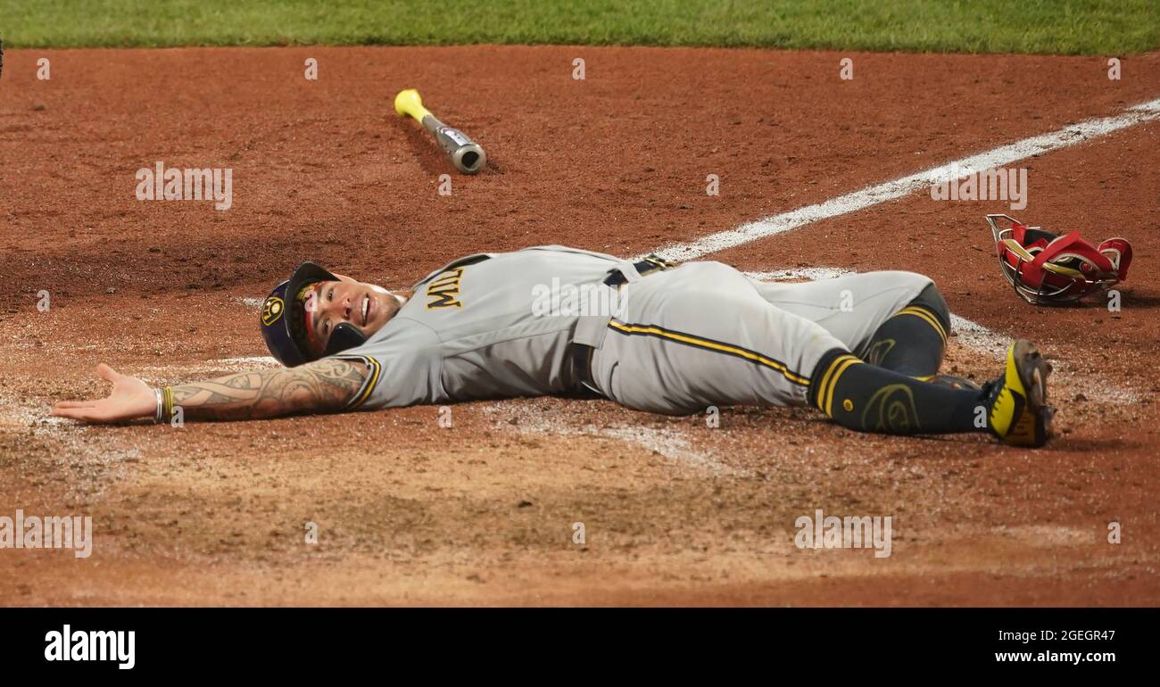 St. Louis, United States. 19th Aug, 2021. Milwaukee Brewers Kolten Wong  smiles as he lays at home plate after sliding safely in the fourth inning  against the St. Louis Cardinals at Busch