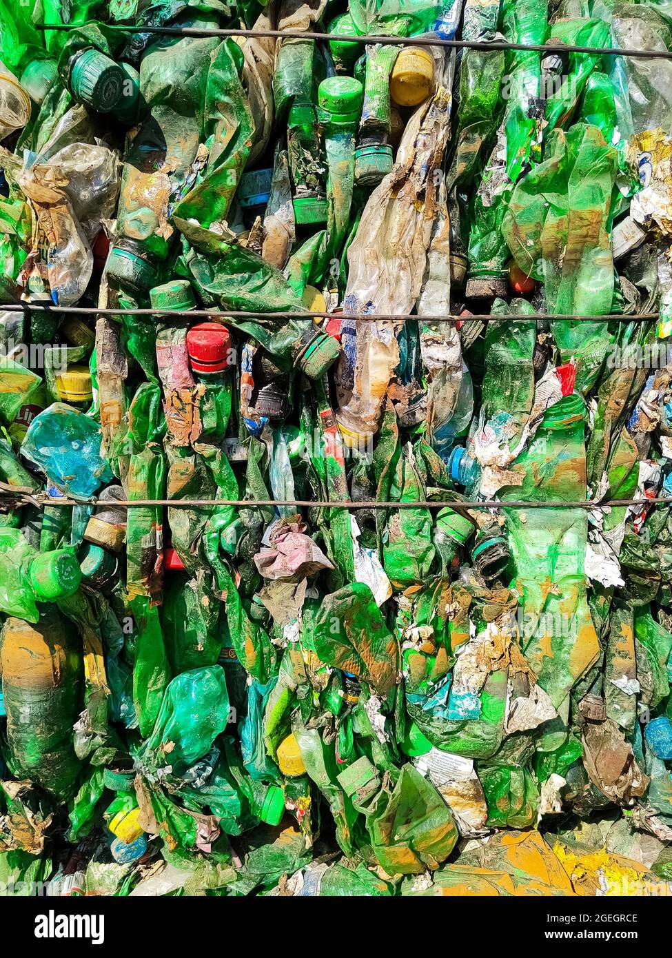 Recycled used plastic bottles in bales at a recycling facility Stock
